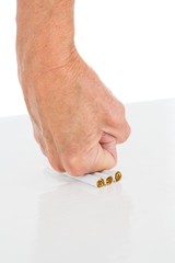 Cropped image of person punching cigarette at table
