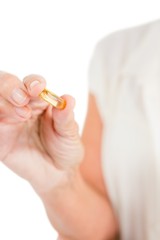 Cropped image of woman showing capsule