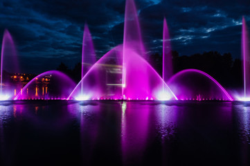 Fototapeta na wymiar Night magic show of fountains on the central waterfront Roshen