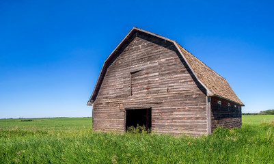 Old barn on the prairies in Saskatchewan on a summer day.