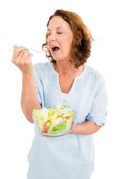 Mature woman having vegetable salad