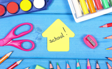 School accessories and shape of building on blue boards, back to school concept