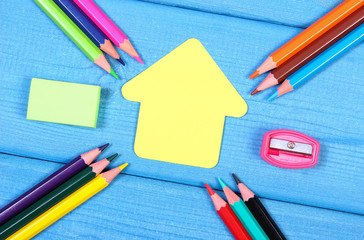 School accessories and shape of school building on blue boards, copy space for text