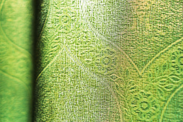 Horizontal vivid green fabric bokeh background