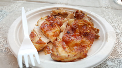 Grilled chicken on paper plate