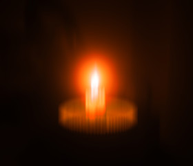 Fire candle in bowl dark composition