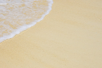beautiful soft wave of the sea on clean sandy beach texture background
