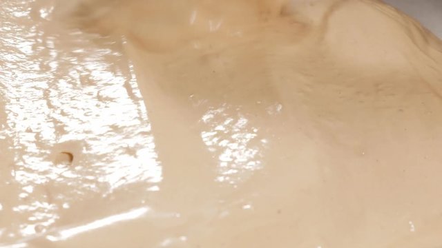 Cream stretching in baking tray 4K 2160p UHD footage - Stretching sweet cream for cake baking in sheet pan 4K 3840X2160 UHD video 