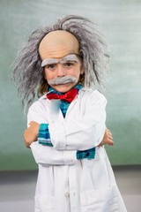 Smiling boy dressed as scientist standing with arms crossed - obrazy, fototapety, plakaty
