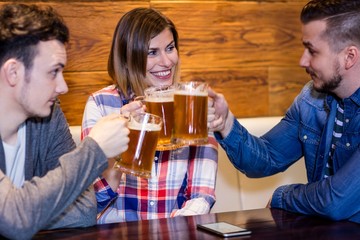 Friends toasting beer at restaurant