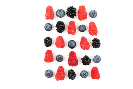 different juicy berries laid out in a square on a white background