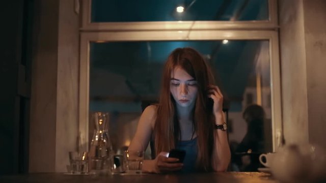 Young woman using cell phone to type text message or communicate
