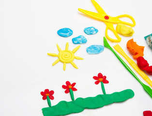 Sun and clouds and flowers made from plasticine