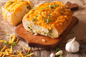 Cheddar bread with garlic and herbs closeup. horizontal
