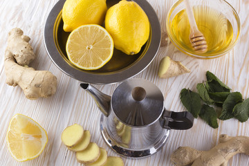Teapot of ginger tea with honey and lemon.