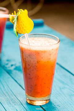 Variety of Fresh Healthy Paleo Smoothies and Cocktails in Rainbow Colors on Blue Wooden Background, Beach Party