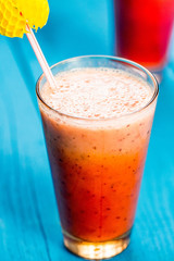 Variety of Fresh Healthy Paleo Smoothies and Cocktails in Rainbow Colors on Blue Wooden Background, Beach Party