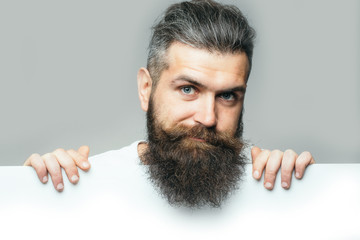 bearded smiling man with paper
