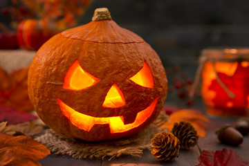 Burning Jack O'Lantern on a rustic table