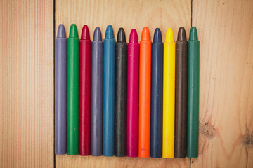 Fototapeta premium Crayon on wood background with copy space
