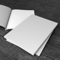 small stack of catalogs or magazines isolated on wooden floor