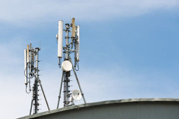 Fototapeta na wymiar Close up white color antenna repeater tower on blue sky