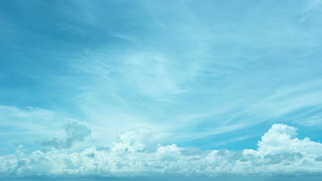 Abstract video of a layer of fluffy storm clouds building and drifting in the bright blue sky, in timelapse. Video 3840x2160