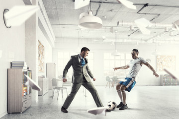 Playing football in office . Mixed media