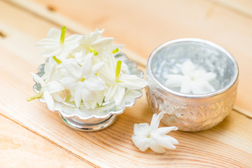 Fototapeta na wymiar water in silver bowl with jasmine white flower, Thailand Songkarn