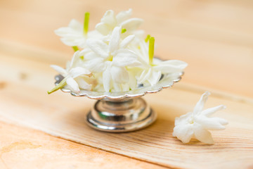jasmine flower on silver tray, Thai white flower on wood background.