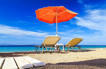 Empty sun loungers on the beach before summer