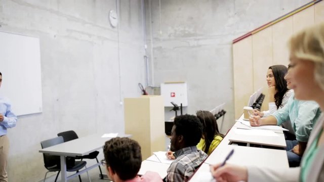 students and teacher at white board on lecture
