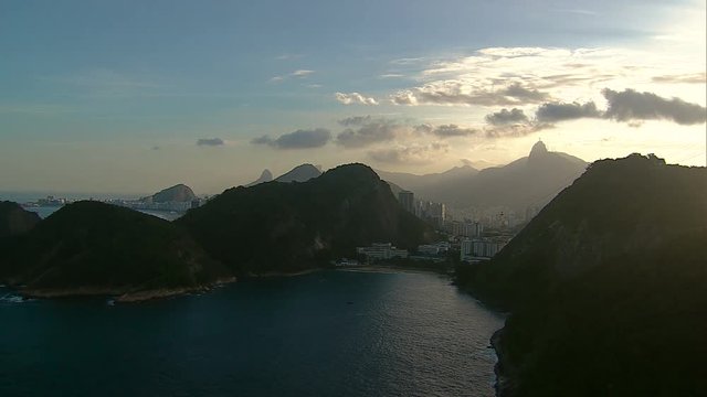 Aerial panning shot towards Rio De Janeiro sunset with Corcovado Hill and Sugar Loaf Mountain, Rio De Janeiro, Brazil