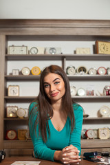 Near the table is smilling woman