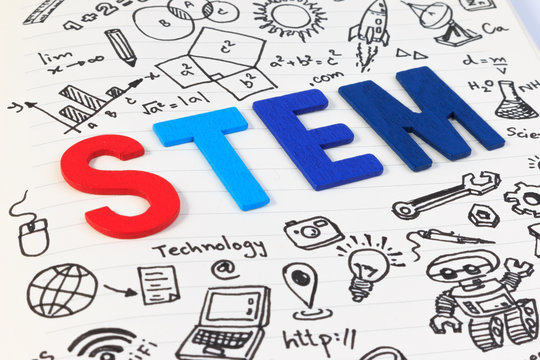 STEM subjects for learning, Science Technology Engineering Mathematics. STEM concept with drawing background. Magnifying glass over education background.