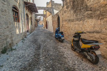 Scooters on the medieval street , Rhodes, Greece