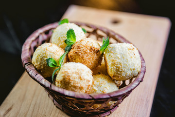 Coconut cookies in a basket with mint, a tasty dessert