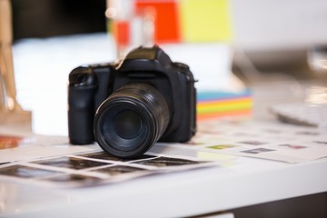 Camera on photographs at desk 