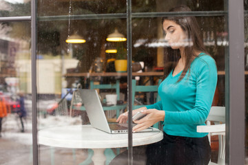 Fototapeta premium In window is woman in blue