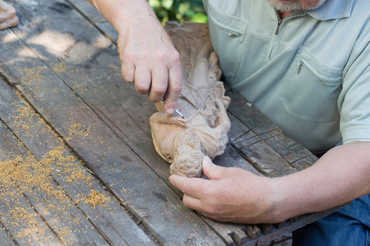 Craftsman carving wood sculpture.hand close up.