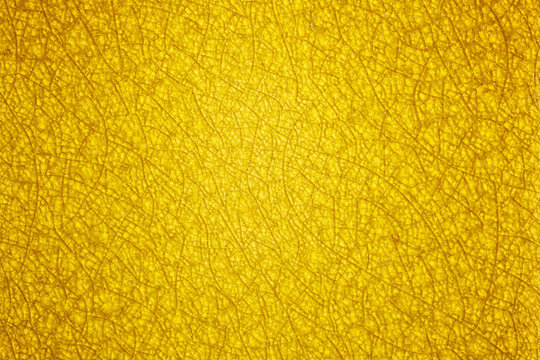 An abstract yellow gold background with a pattern of glass crack