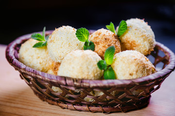 Coconut cookies in a basket with mint, a tasty dessert