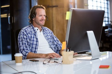 Businessman smiling while using computer