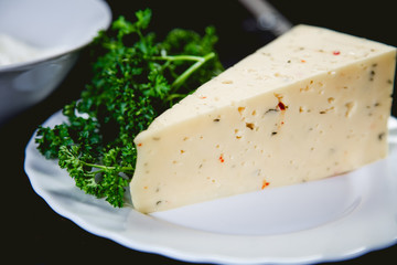 piece of cheese, herbs, food ingredients
