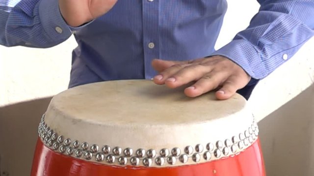 Man playing Bongo drum close up HD stock footage. Slow motion.
