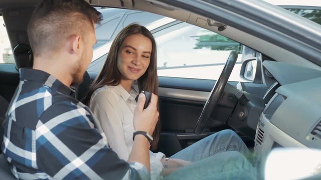 Young Beautiful Woman Getting a Driving Lesson In The Car