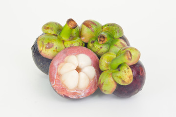 Mangosteen fruit with half cross section isolated on wooden boar