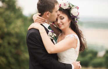 Beautiful romantic wedding couple of newlyweds hugging near old castle 