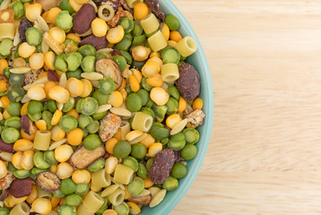 Minestrone soup mix in a bowl on a wood table.