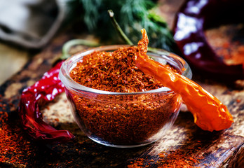 Ground dried red cayenne pepper, rustic style, selective focus o